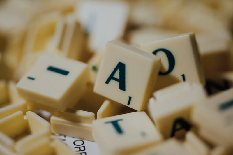 Close-up of letter blocks spelling the word TAX, illustrating the concept of sales tax components
