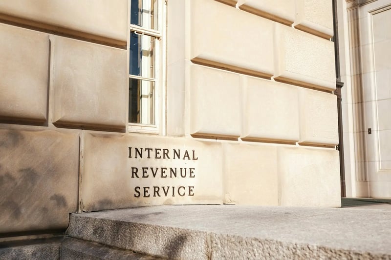 A modern office building with the words GST prominently displayed on the facade